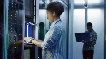 Une femme travaille sur ordinateur dans un data center